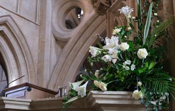 A large bouquet of white flowers in a church