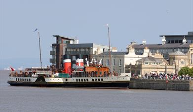 A paddle steamer docked in a harbour