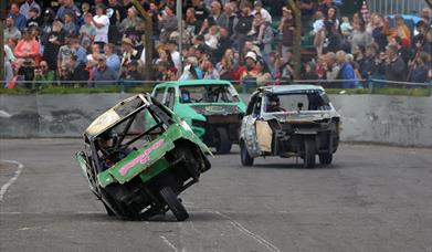 Three Robin Reliant cars in a banger racing race