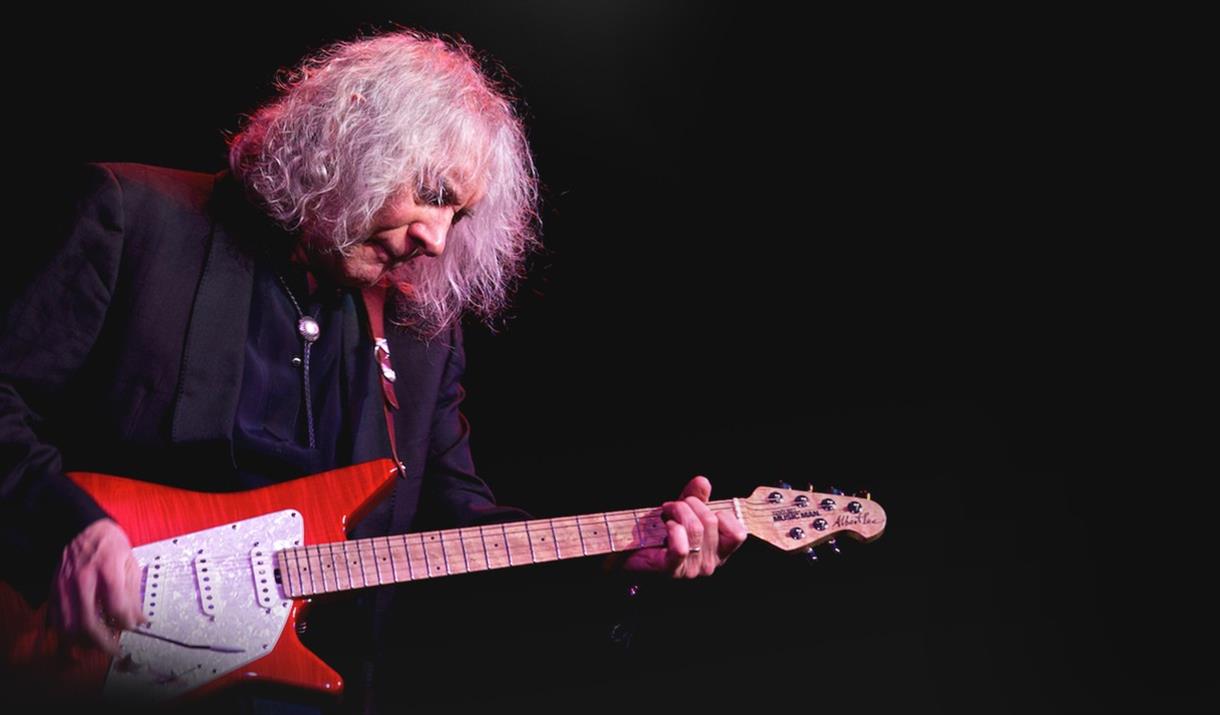 Albert Lee playing a red guitar