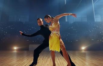 A ballroom dancing couple performing