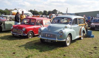 A Morris Minor and a red Mini from previous displays