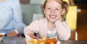 Grand Pier Boardwalk Restaurant Weston-super-Mare smiling child dining in