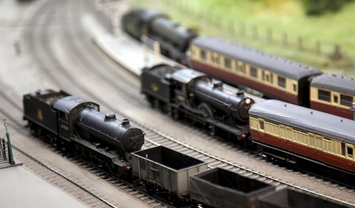 Three model steam trains on a model railway set Three model steam trains on a model railway set