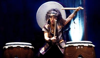 Photograph of Taiko Drummer playing two drums