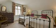 Period Victorian bedroom with two beds furnished in the style of the era