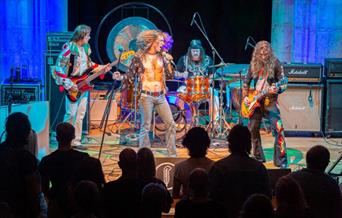 Led Zeppelin Tribute band performing on stage.