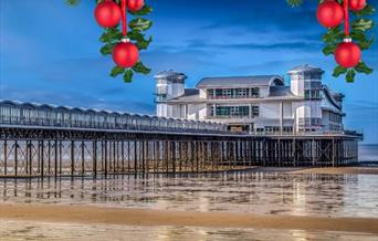 View of a seaside pier with some Christmas decorations overlaid