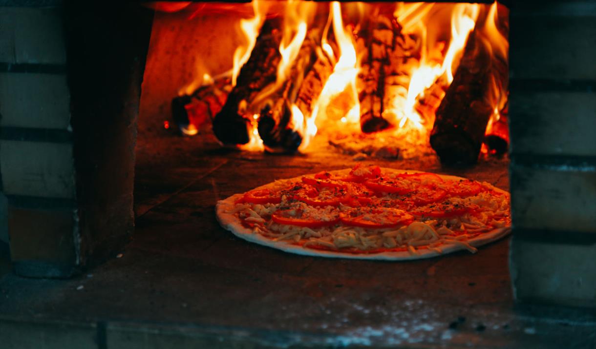 Enjoy tasty wood-fired pizzas
