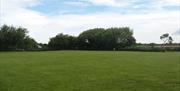 The well kept field ready for touring caravans, motorhomes and tents to arrive
