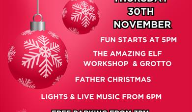 Poster with red and white baubles advertising a Christmas lights switch on