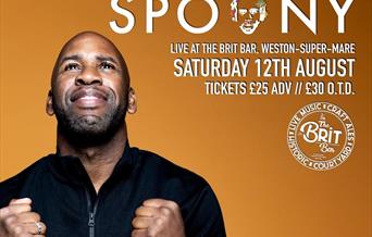 Mug shot of DJ Spoony looking upwards with his clenched fists down by his chest.