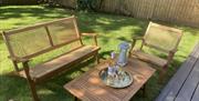 Outside garden table and chairs set with wine and glasses
