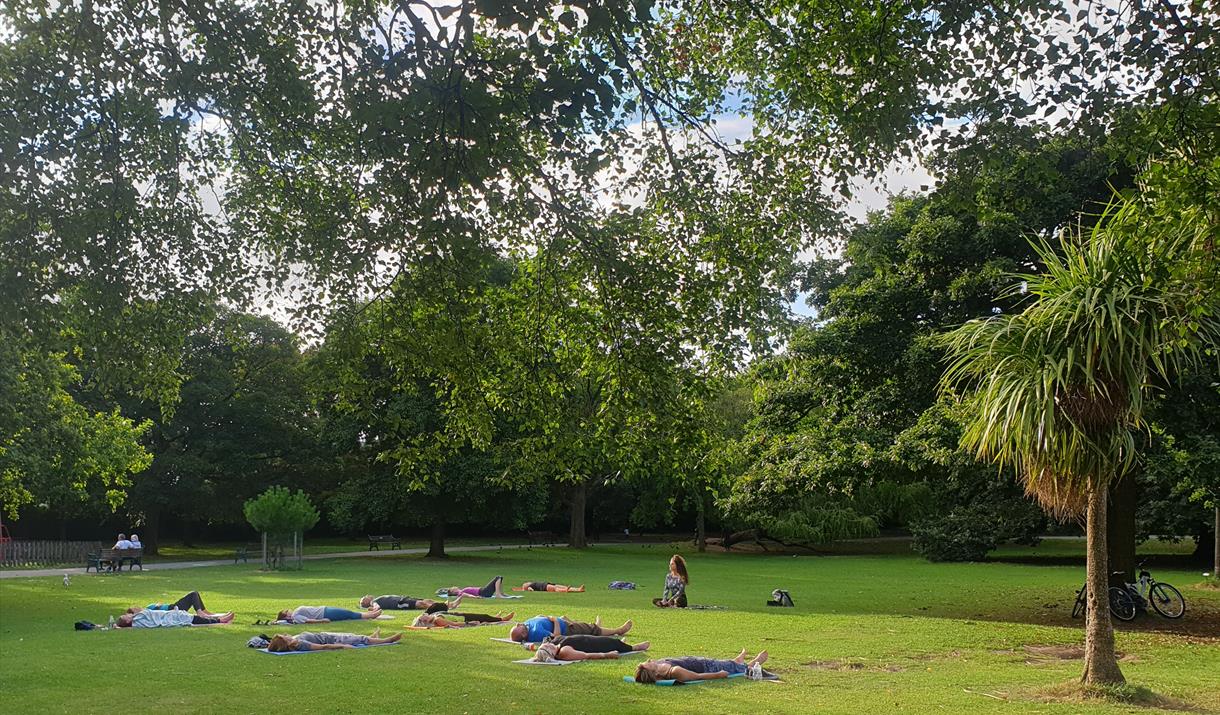 People do Yoga in the park
