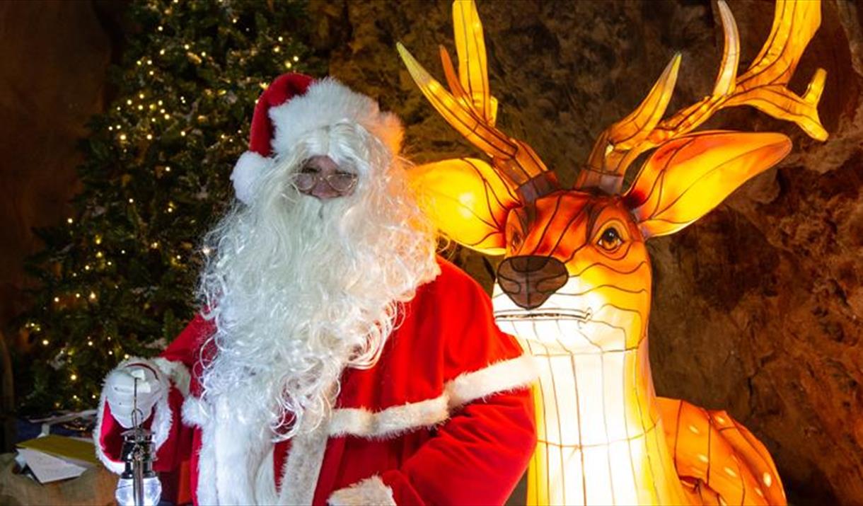 Father Christmas with a lit up model reindeer