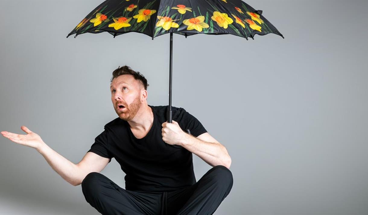 Jason Byrne with opened umbrella