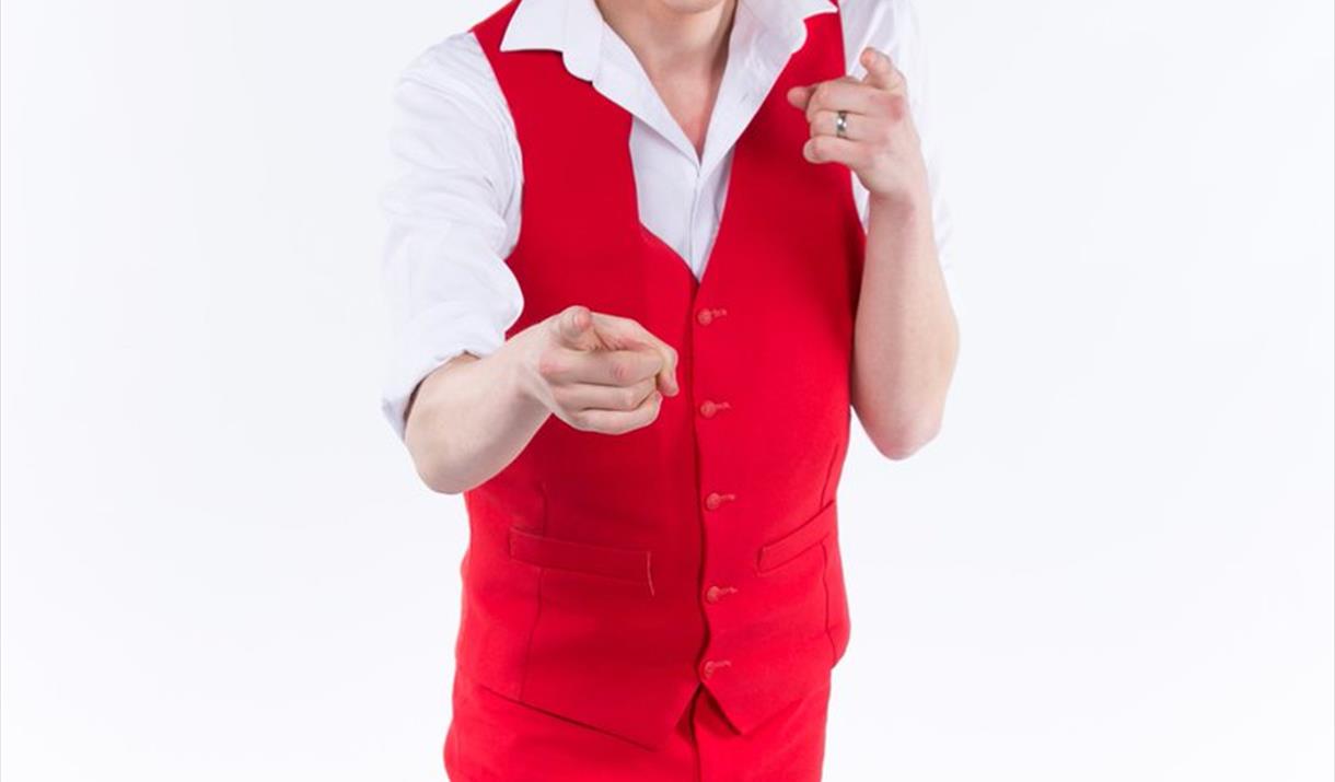 Comedian wearing red waistcoat and trousers