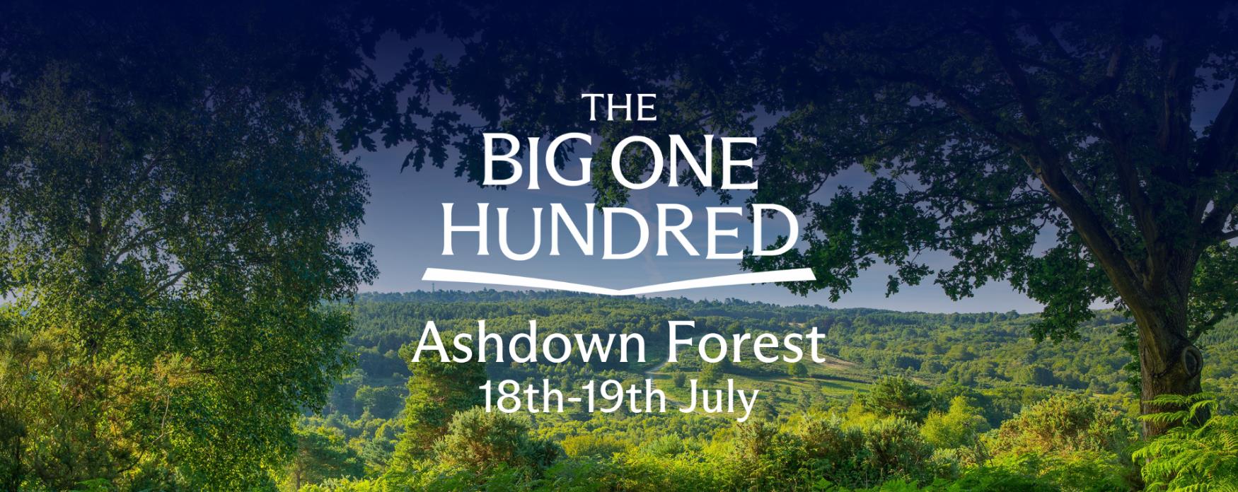 Panoramic view of Ashdown Forest with lush green woodland and rolling hills, framed by trees, with “The Big One Hundred – Ashdown Forest 18th–19th July” text overlaid.