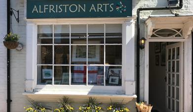 The front of Alfriston Arts Gallery, with four flower pots underneath the window