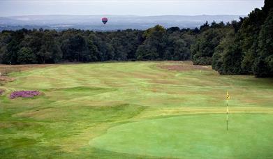 Crowborough Golf greens with hot air balloon flying over