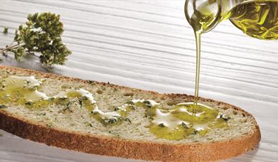 Oil pouring on bread