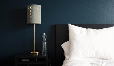 Hotel bedroom with lamp on table