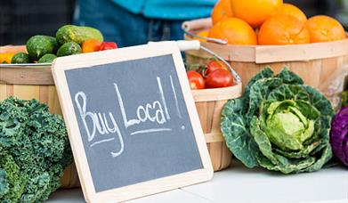 Buy local sign with vegetables