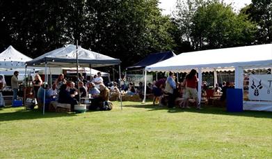 people sitting in a beer garden on a field