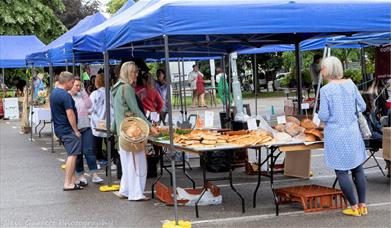 A car park with market stalls filled with food