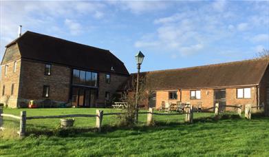 converted 1824 barn surrounded by green grass