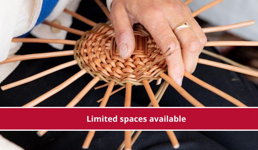 Close-up of hands weaving a circular basket with willow rods, with a red banner reading “Limited spaces available.”