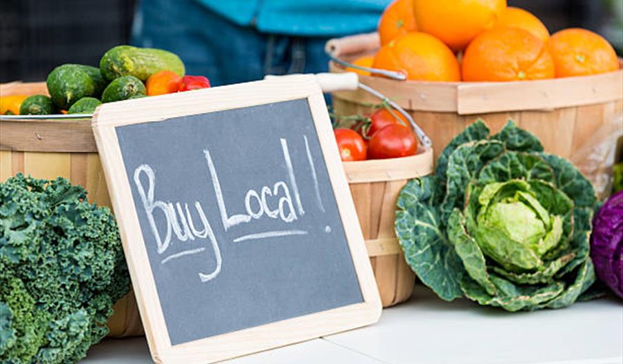 Buy local sign with vegetables