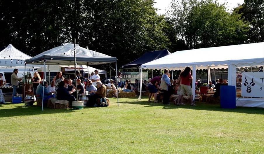people sitting in a beer garden on a field