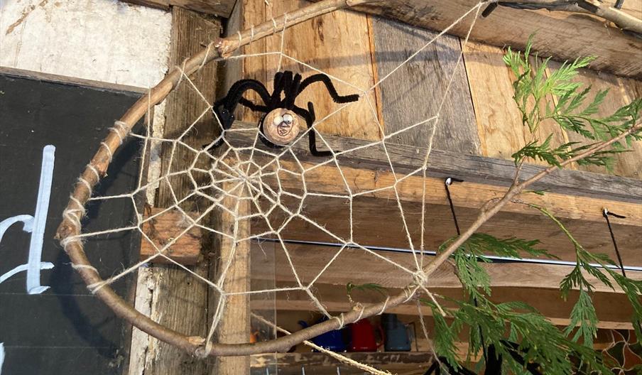a hand crafted spider on a string spider-web