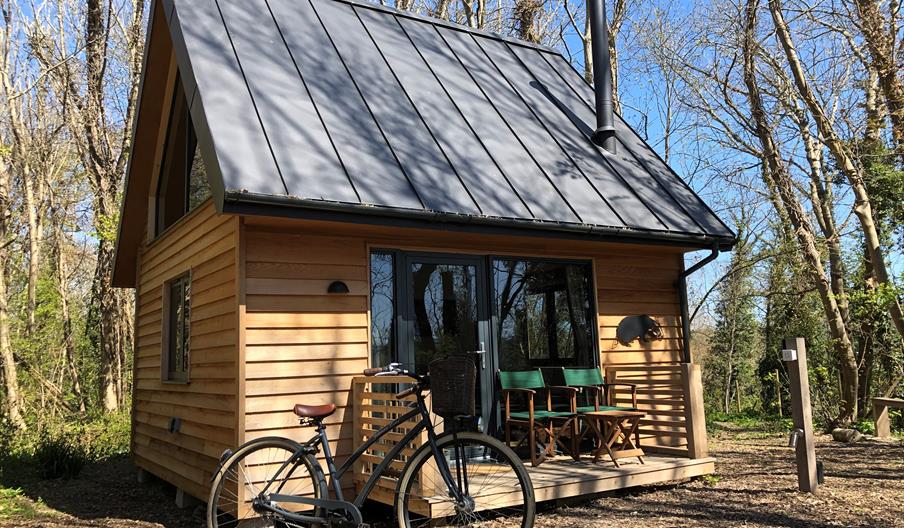 Alfriston Wood Cabins exterior shot with bike