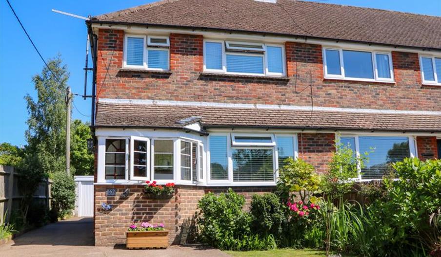 semi-detached house with driveway and small garden out the front