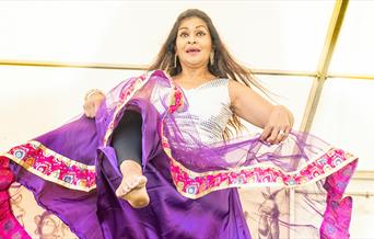 A woman dancing in bollywood dress style