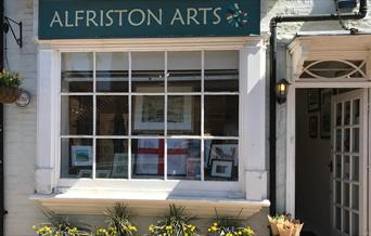 The front of Alfriston Arts Gallery, with four flower pots underneath the window