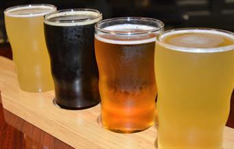 four glasses of different beers