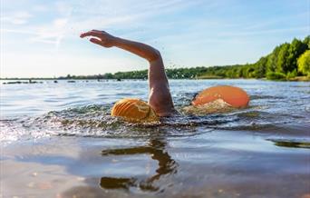 Lady swimming in Bewl Water's water