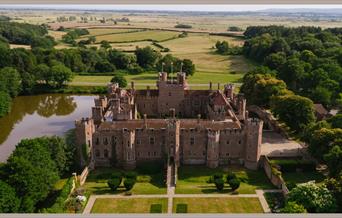 An ariel shot of Herstmonceux Castle, a red-brick castle surrounded by a moat