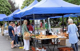 A car park with market stalls filled with food