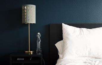 Hotel bedroom with lamp on table