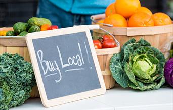 Buy local sign with vegetables