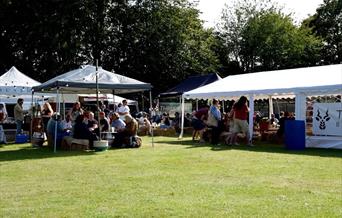 people sitting in a beer garden on a field