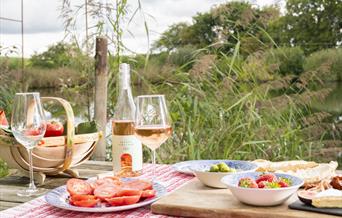 picnic table full of snacks and there wine made at the vineyard