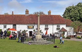 Exterior shot of Tiger inn with people sitting outside