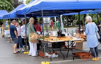 A car park with market stalls filled with food
