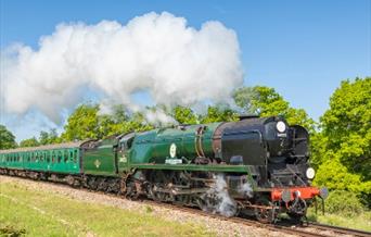 A vintage steam train travelling in the countryside