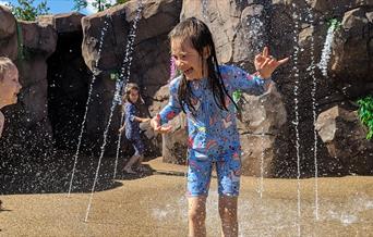 image of a girl playing in the jungle splash